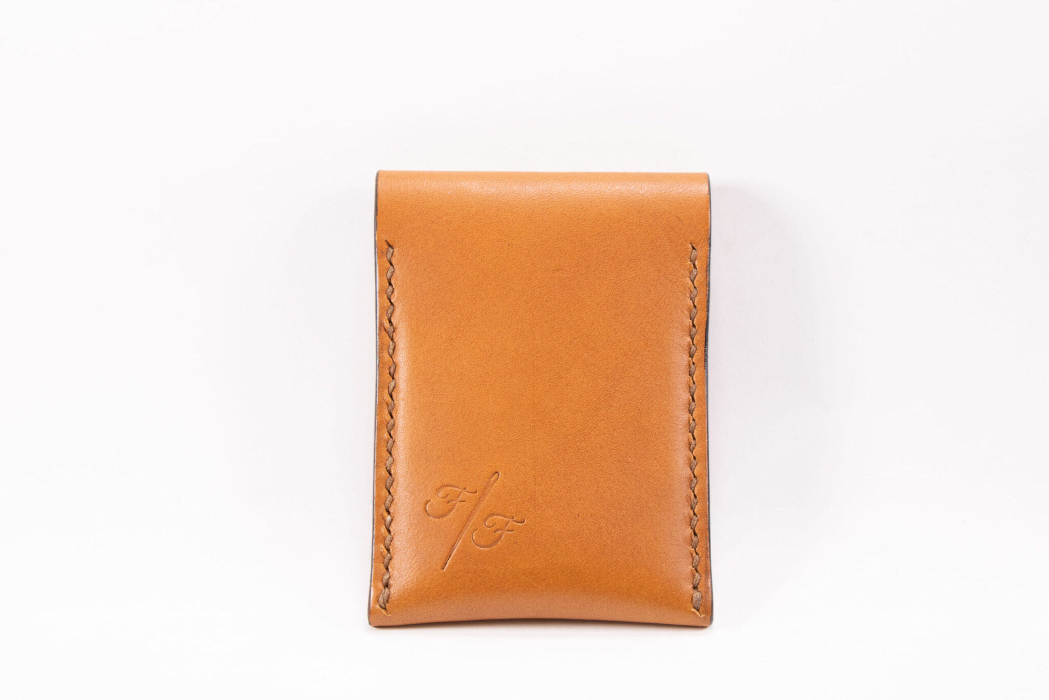 Tinier Pouch - Slim pocket card wallets Handmade from European Leather. 4-8 card wallets made from Vegetable-tanned leather available in cognac color. Sizes 70 mm & 80mm wallet leather made in Sweden.