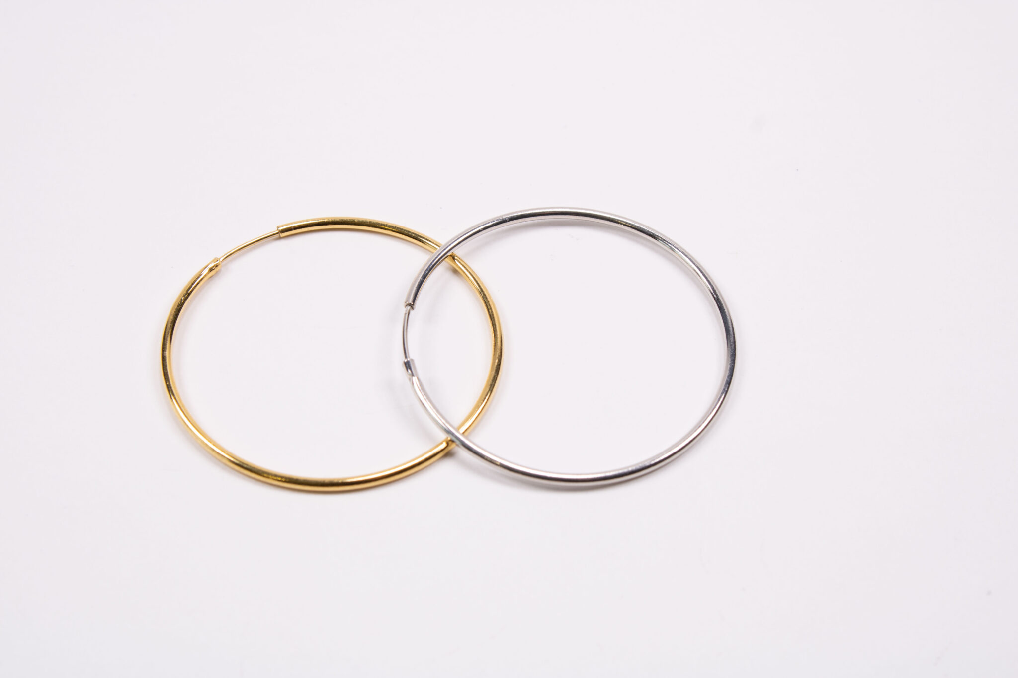 Product image of FredFloris large round hoop gold and silver earrings