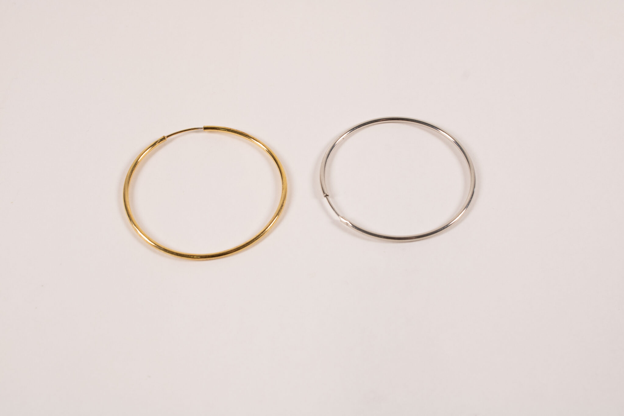 Product image of FredFloris large round hoop gold and silver earrings